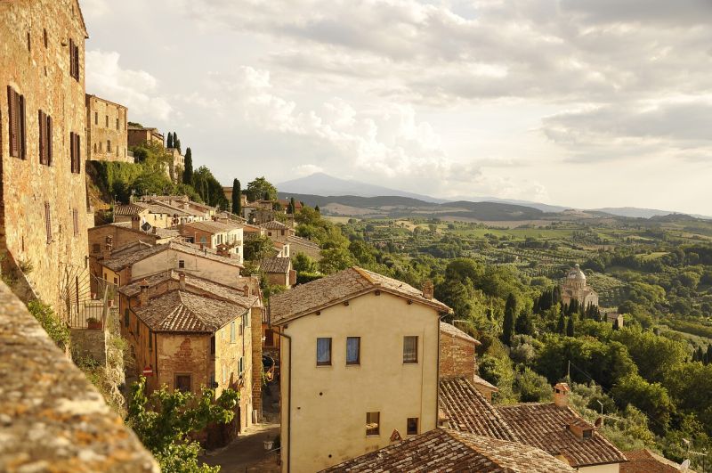 A hillside village in Tuscany with stone buildings.
