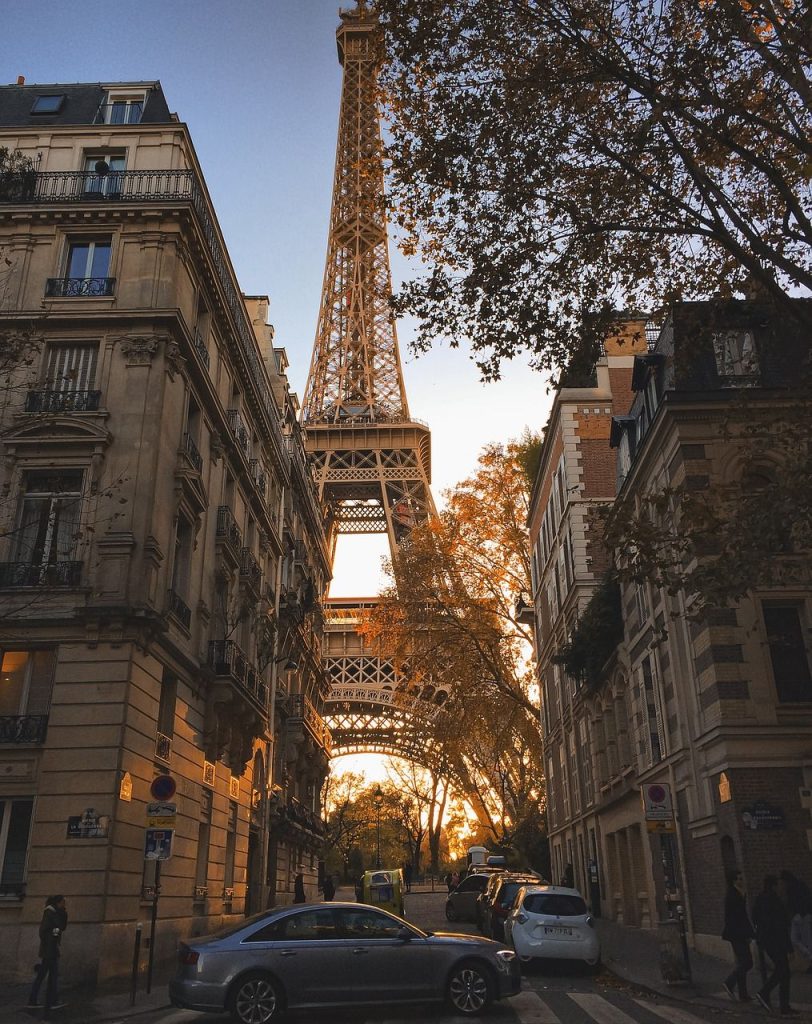 The Eiffel tower seen between two buildings in Paris.
